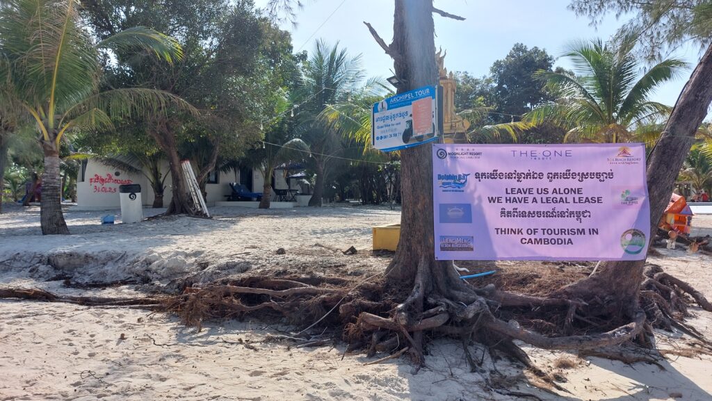 A poster created by owners of condemned guesthouses requesting authorities to "leave us alone" on at the Saracen Bay resort area on Koh Rong Sanloem island on February 4, 2023. (Danielle Keeton-Olsen/VOD)