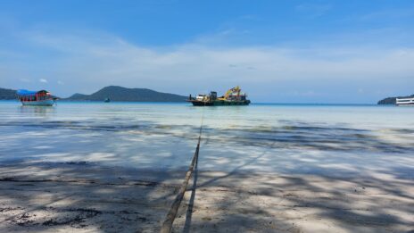 A boat loaded with an excavator and other heavy machinery is anchored at Koh Rong Sanloem island's Saracen Bay on February 4, 2023. (Danielle Keeton-Olsen/VOD)